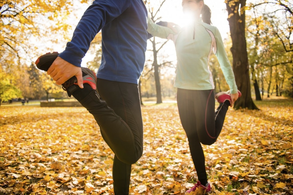 two people stretching before a run