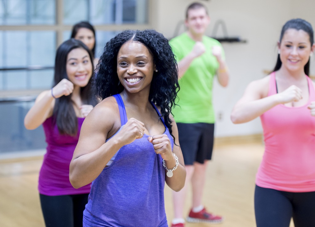 People in bright shirts enjoying a workout class