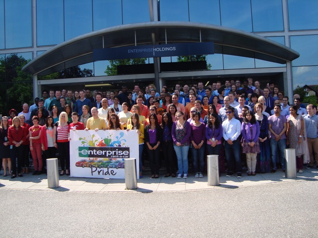 Enterprise Employees in front of Enterprise building with Pride banner